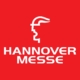 Logo mit weiße Schrift "Hannover Messe" auf rotem Hintergrund und Grafikelement